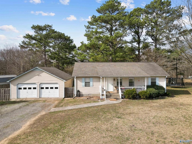 ranch-style house featuring a porch, a trampoline, and a front lawn