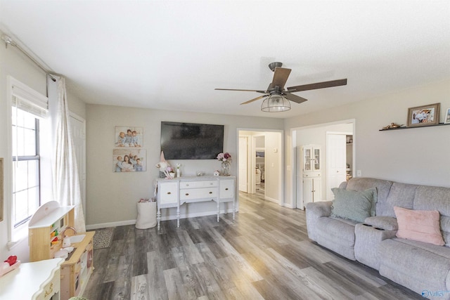 living room featuring hardwood / wood-style flooring and ceiling fan