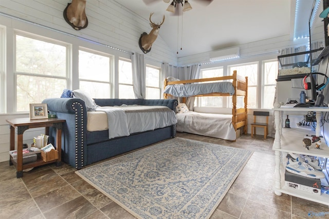 bedroom with vaulted ceiling and a wall unit AC