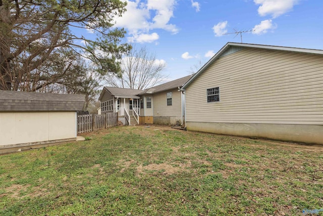 rear view of property with a lawn