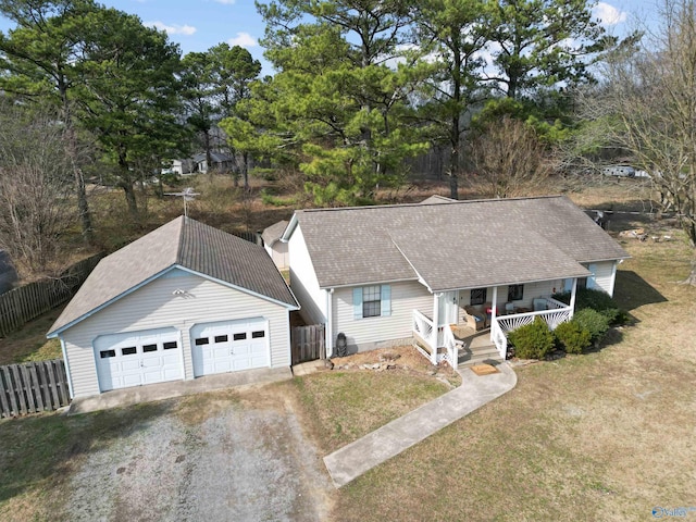 single story home with a porch, a garage, and a front lawn