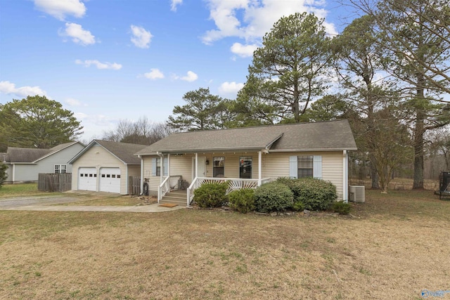 ranch-style home featuring a garage, a front yard, central AC unit, and covered porch