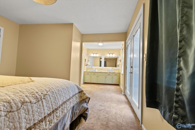 bedroom with light carpet and ensuite bath