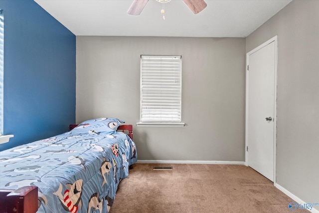 unfurnished bedroom featuring carpet floors, visible vents, baseboards, and a ceiling fan