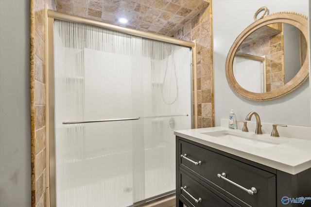 bathroom with vanity and a shower with shower door