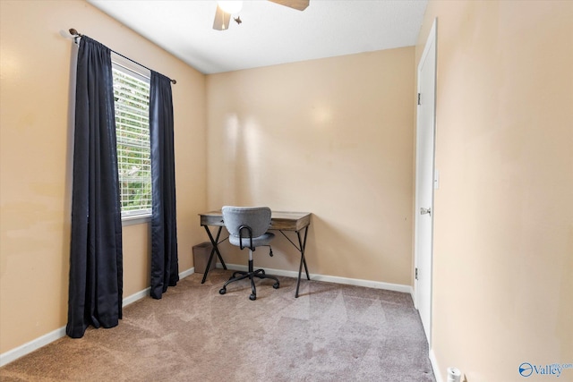 office area featuring baseboards, a ceiling fan, and light colored carpet