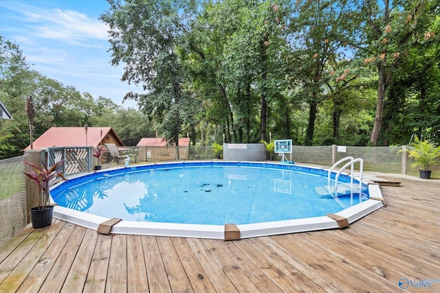 outdoor pool featuring a deck and fence