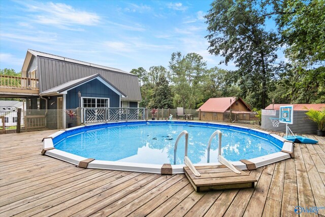 view of pool featuring fence, a fenced in pool, and a wooden deck