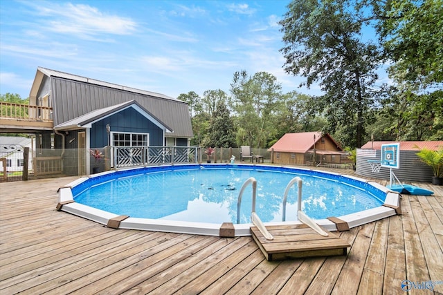 view of pool featuring a fenced in pool, fence, and a wooden deck