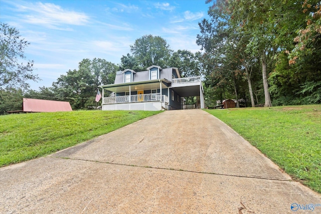 view of front of property featuring a front yard, covered porch, an attached carport, and concrete driveway