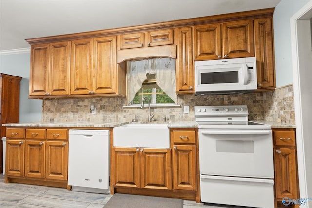 kitchen featuring white appliances, decorative backsplash, brown cabinets, light countertops, and a sink