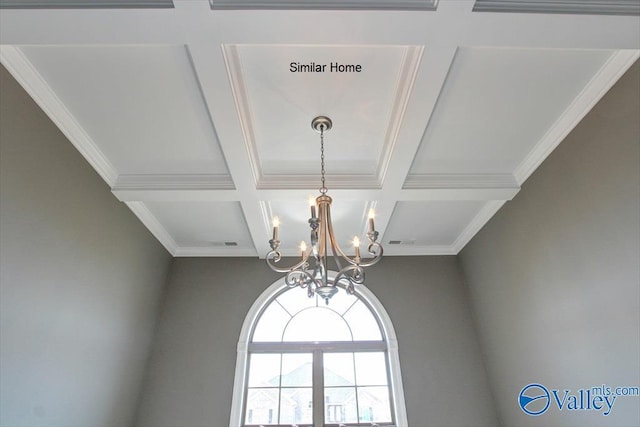 interior details with coffered ceiling, beam ceiling, crown molding, and a chandelier