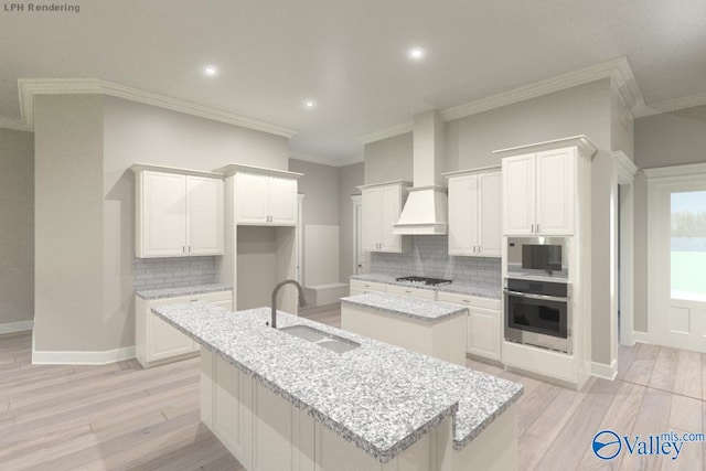 kitchen featuring sink, white cabinets, stainless steel appliances, light stone countertops, and a center island with sink