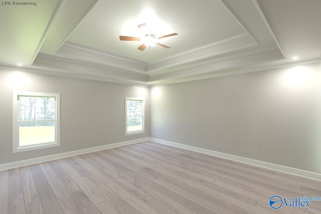 unfurnished room featuring crown molding, a tray ceiling, ceiling fan, and light wood-type flooring