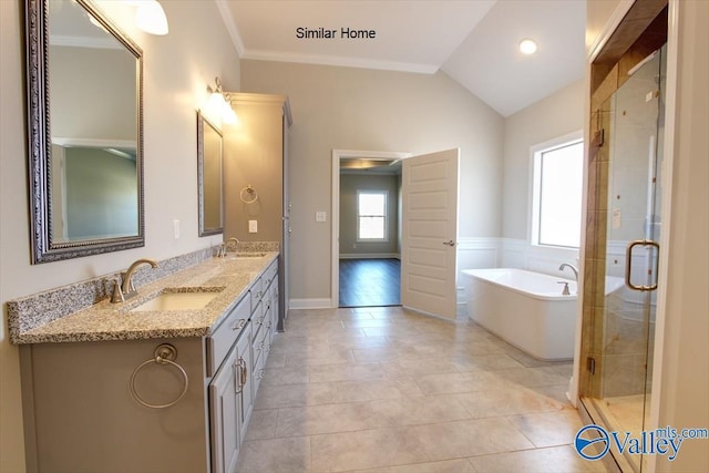 bathroom featuring plus walk in shower, lofted ceiling, tile patterned flooring, vanity, and crown molding