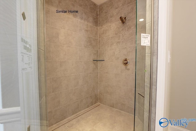 bathroom featuring a shower with door