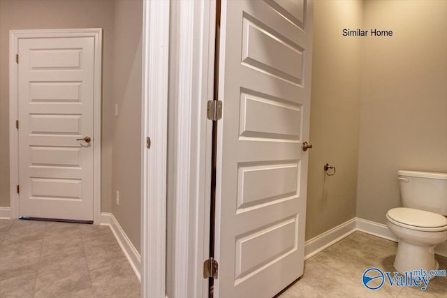 bathroom with tile patterned flooring and toilet