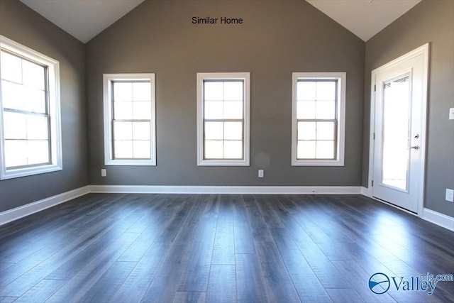 unfurnished room featuring dark hardwood / wood-style flooring and lofted ceiling