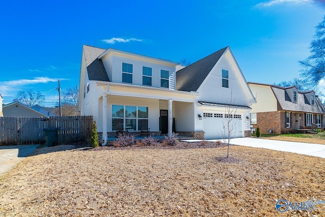 view of front of property featuring a porch, concrete driveway, fence, and an attached garage