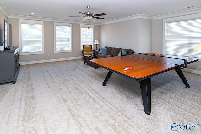 playroom featuring light colored carpet, a healthy amount of sunlight, and ornamental molding