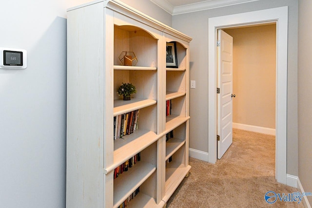 corridor with baseboards, carpet, and crown molding