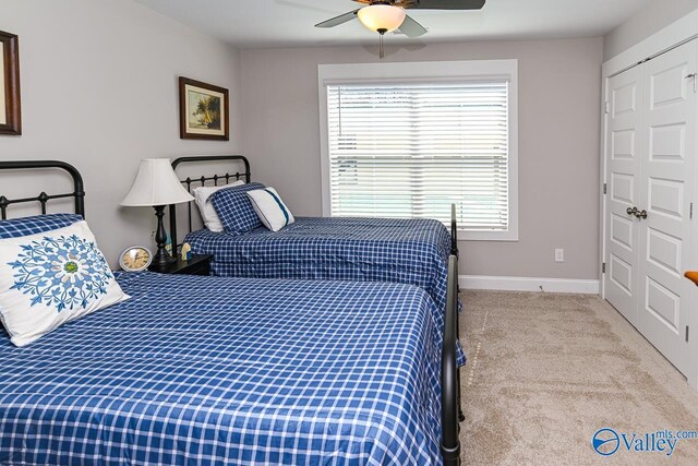 bedroom with baseboards, carpet floors, and ceiling fan