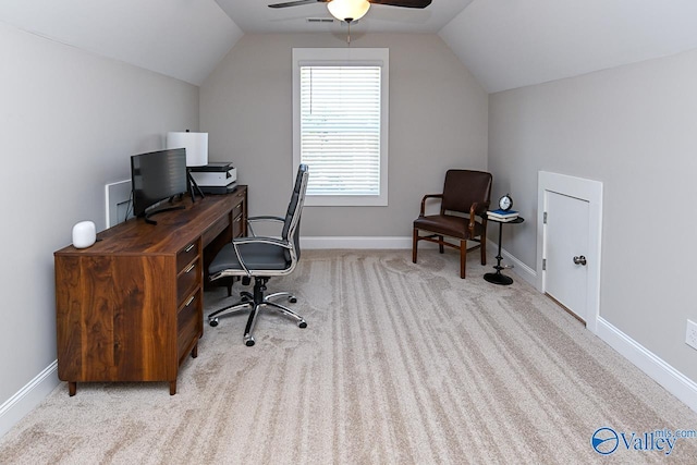 carpeted home office with visible vents, baseboards, and vaulted ceiling