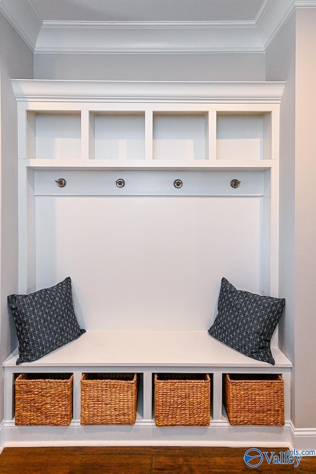 mudroom featuring baseboards and crown molding