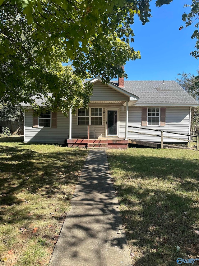 ranch-style house featuring a front lawn and a wooden deck