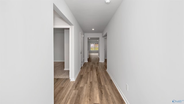 hallway with hardwood / wood-style flooring