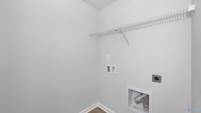 clothes washing area featuring hookup for a washing machine, wood-type flooring, and hookup for an electric dryer