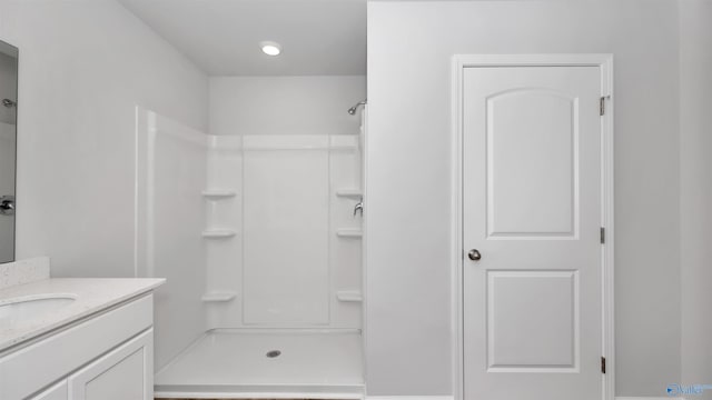 bathroom with vanity and a shower