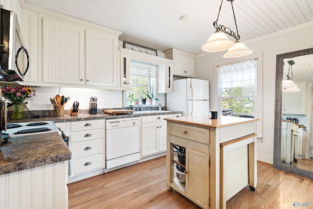 kitchen with dark countertops, white appliances, pendant lighting, and light wood finished floors