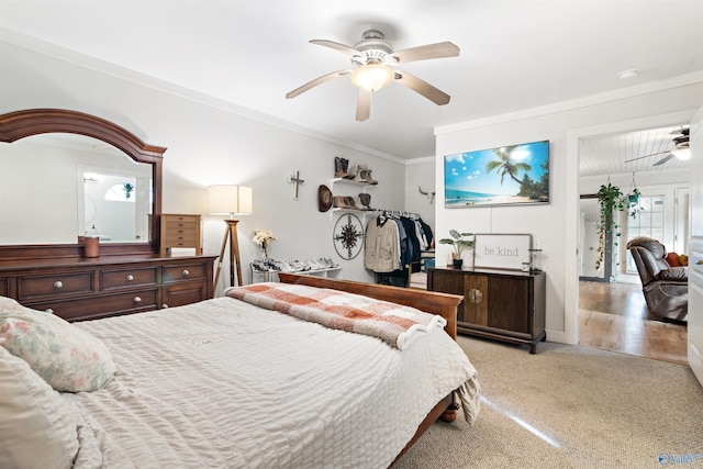 bedroom with ornamental molding, carpet flooring, and a ceiling fan