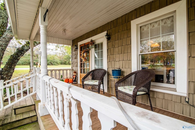 wooden terrace featuring covered porch