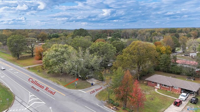 drone / aerial view featuring a wooded view