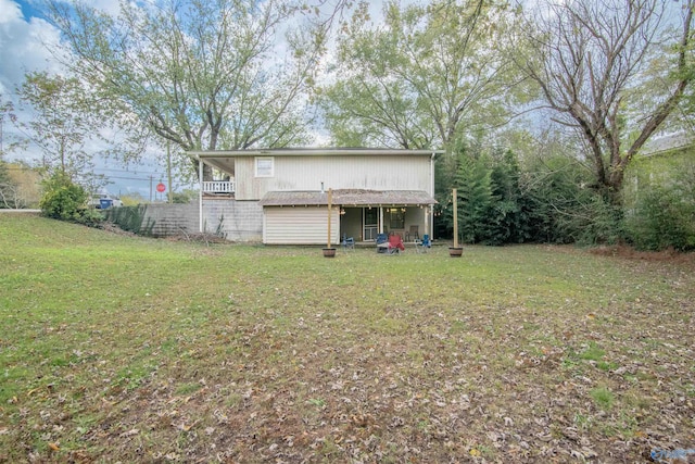 rear view of property featuring a yard