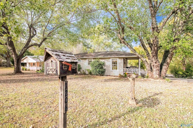 ranch-style home featuring an outbuilding and a storage shed