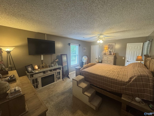 bedroom featuring ceiling fan, a textured ceiling, and carpet floors
