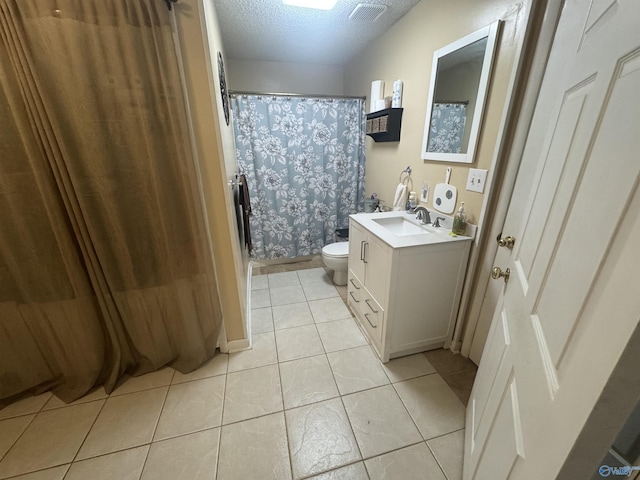 full bathroom with a textured ceiling, toilet, visible vents, tile patterned flooring, and vanity