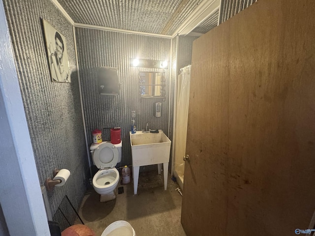 bathroom with toilet, unfinished concrete floors, and shower / bath combination with curtain