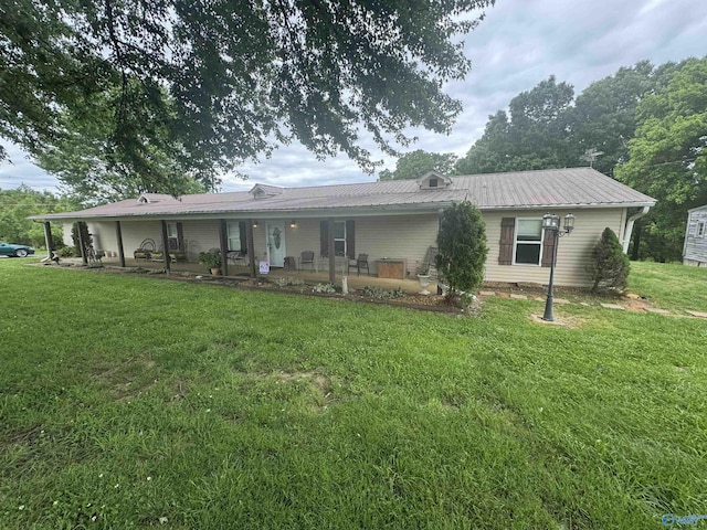 back of property featuring a yard, metal roof, and a porch