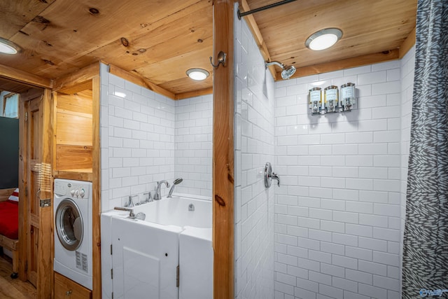 washroom featuring washer / dryer and wooden ceiling