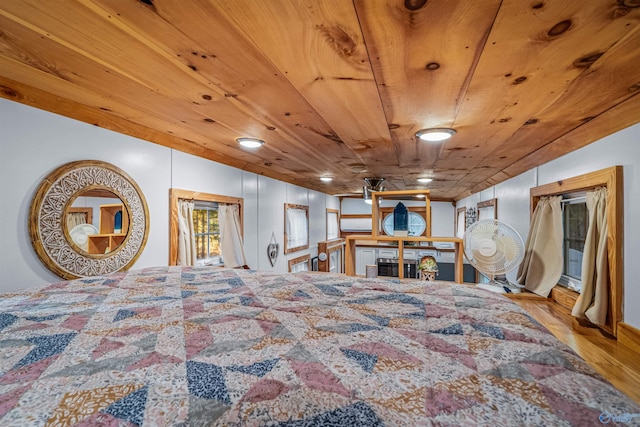 bedroom featuring light hardwood / wood-style floors and wood ceiling