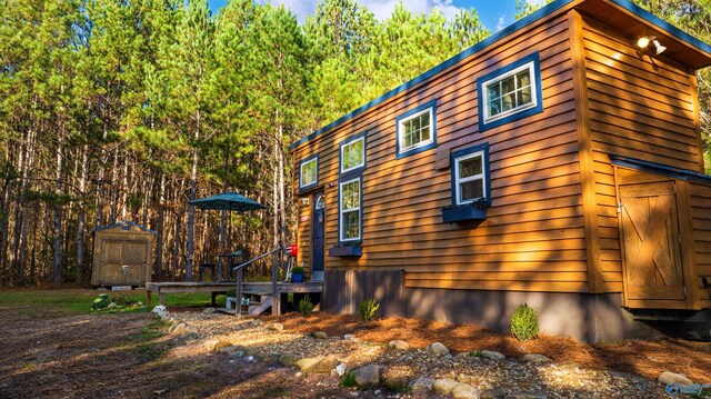 view of home's exterior featuring a shed