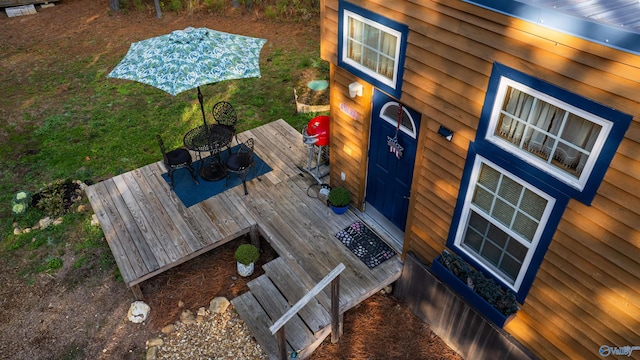 wooden terrace with a yard