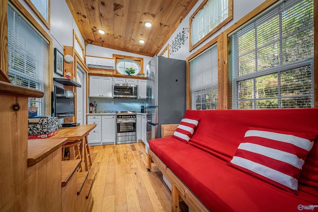 kitchen featuring appliances with stainless steel finishes, light wood-type flooring, wood ceiling, high vaulted ceiling, and white cabinetry