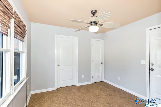 unfurnished bedroom with light wood-style flooring, baseboards, and a ceiling fan