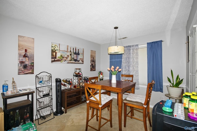 dining room featuring visible vents and a textured ceiling