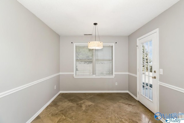 unfurnished dining area with visible vents and baseboards